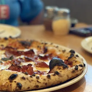 a pizza on a plate on a table