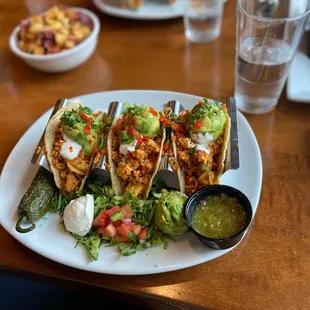 a plate of tacos and a bowl of salsa