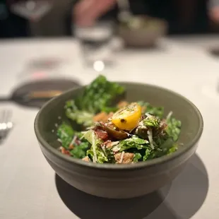 a bowl of salad on a table