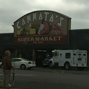 a man standing in front of the store