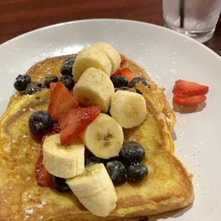 Red, white, and blue french toast (without whipped cream) with a side of cheesy potatoes.