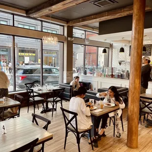 people sitting at tables in a restaurant