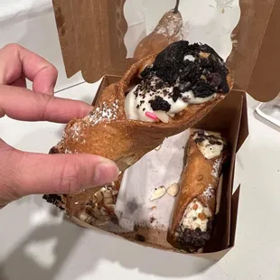 a hand holding a pastry