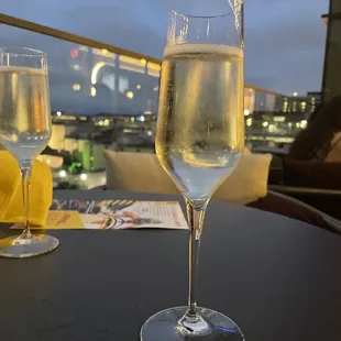 two glasses of champagne on a table