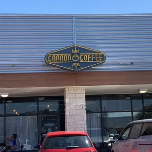 cars parked in front of a coffee shop