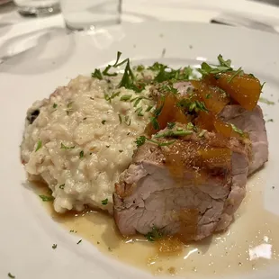 From the 2023 holiday musical show menu: Course 3 -- slow braised pork loin with apricot glaze and risotto
