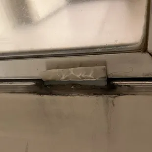 Moldy shower door track that is broken to boot