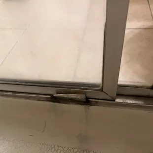 Moldy shower door track that is broken to boot