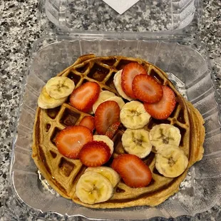 a waffle with strawberries and bananas