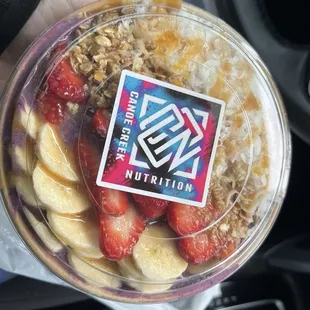 Açaí bowl with granola ,coconut ,strawberries ,bananas and caramel sauce,