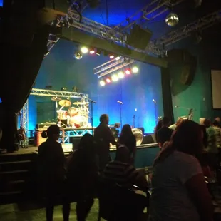 a crowd of people watching a performer on stage