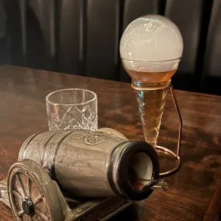 a glass of beer and a beer keg on a table