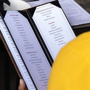 a person holding a menu