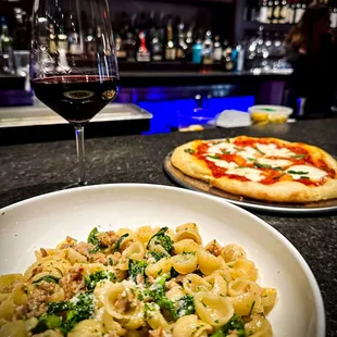 a plate of pasta and a glass of wine