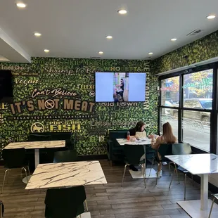 a woman sitting at a table in a restaurant