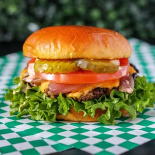 a hamburger with lettuce, tomato, and pickles