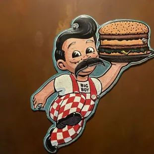 a man holding a tray with a hamburger on it