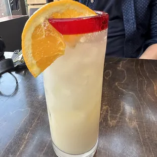 a man sitting at a table with a drink