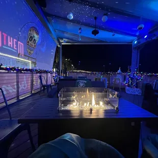 a patio with a fire pit