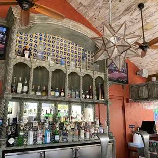 a bar with a ceiling fan