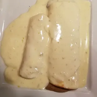 Cheese enchilada (left)  and bean burrito (right) with cheese sauce on top