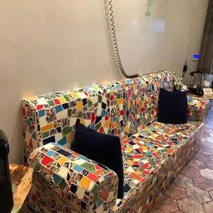 a couch covered in colorful tiles