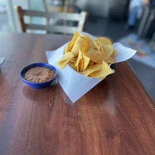 a bowl of chips and a bowl of salsa