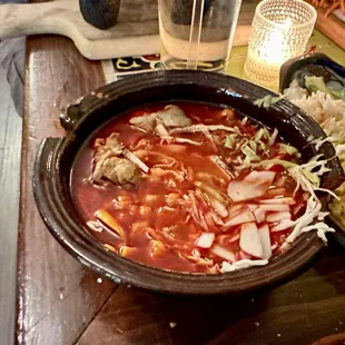 Ramen pozole (ramen noodles, pozole rojo, boiled egg, lettuce, cabbage, corn nuts, queso, crema, radishes)