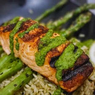 Blackened Salmon w/ chimichurri on top of cilantro lime rice and asparagus.