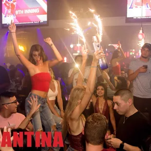 a group of people celebrating with sparklers