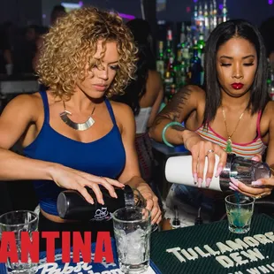 two women pouring drinks