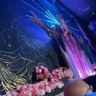 By our booth on the wall they have a big mural of Walter Mercado. It was beautiful and the lights were amazing