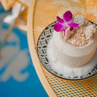 a cantaloupe with a purple flower on top