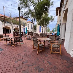 a patio area with tables and chairs