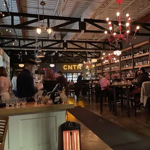 people sitting at tables in a restaurant