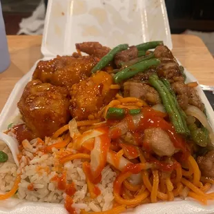 Half noodle and rice. Orange chicken and green beans witch Chicken.