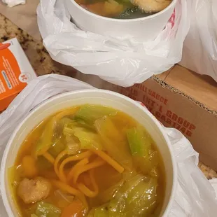 a bowl of soup and a bag of noodles