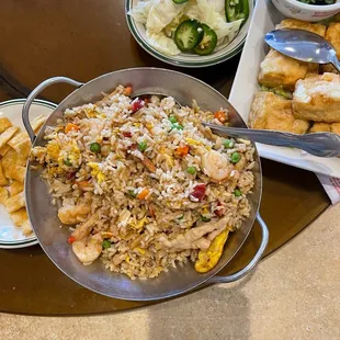 a plate of fried rice with chicken and vegetables