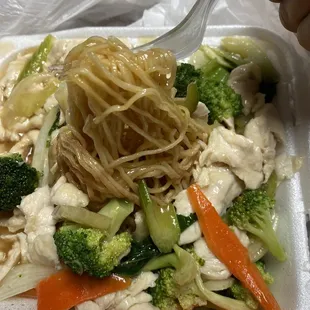 Noodles beneath the toppings of Cantonese dish