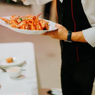 Lobsters with ginger scallion being served