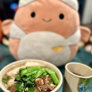 a bowl of soup and a stuffed animal