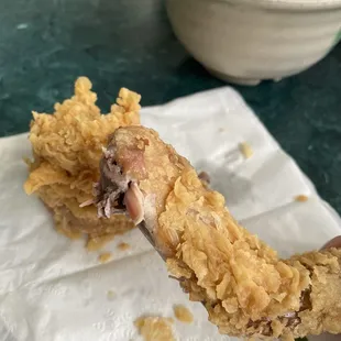 A bite of the best fried chicken skin.