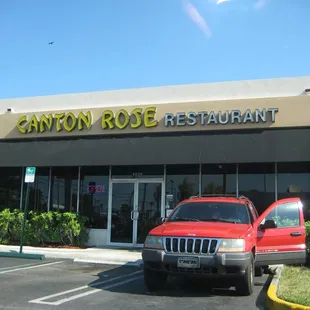 a red truck parked in front of a restaurant