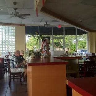 a woman sitting at a table in a restaurant