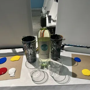 Bottle of wine with our blank canvases and paint palettes