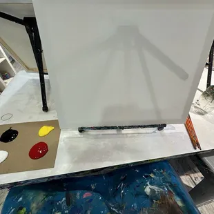 Blank canvas, plenty of paint, brushes and jar of water for cleaning brushes.