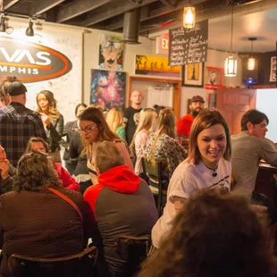 a group of people sitting at a bar