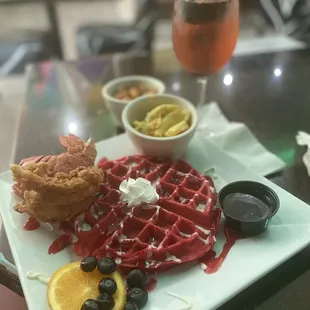 a plate of waffles and fruit