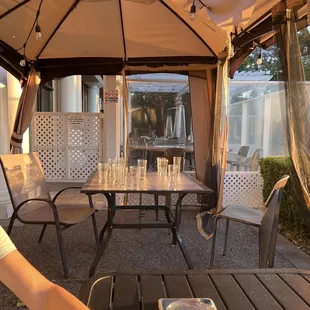 God awful "tent" that's torn and an eyesore. Not a fan of miss matched chairs either :/