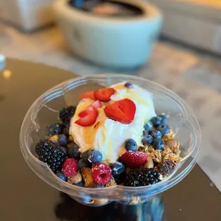 Delicious yogurt bowl with honey, granola and fresh berries